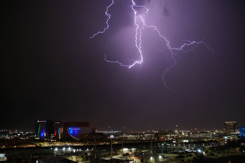 Branching lightning spreads like a tree across a dark purple sky over the World Market Center in downtown Las Vegas