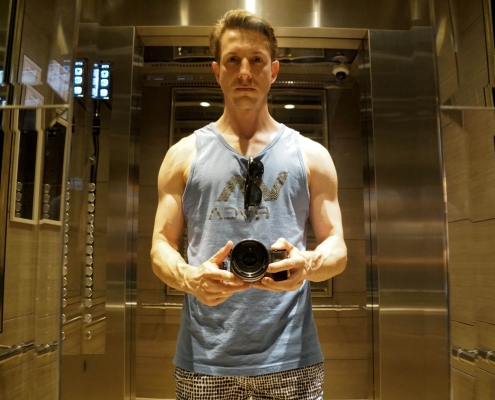 Matt McWilliam holding a Sony digital camera in an elevator in Bangkok, Thailand
